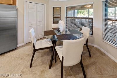 9844 Venezia Circle, Unit 721 Naples, FL 34113 - Photo 6 of 50 a view of a dining room with furniture and wooden floor