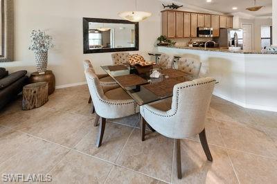 9844 Venezia Circle, Unit 721 Naples, FL 34113 - Photo 8 of 50 a living room with furniture and a flat screen tv