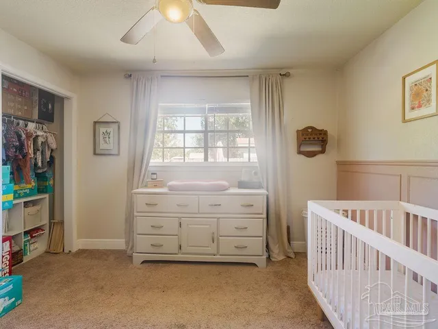a bedroom with a baby bed baby crib and a dresser