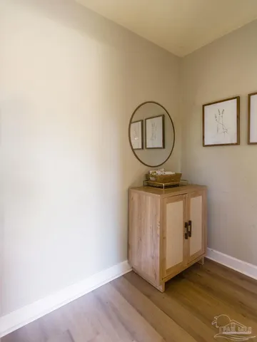 a view of a room with wooden floor and white wall