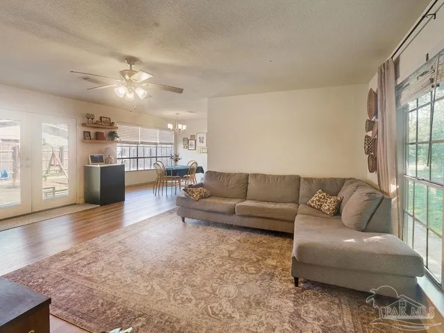 a living room with furniture and a kitchen