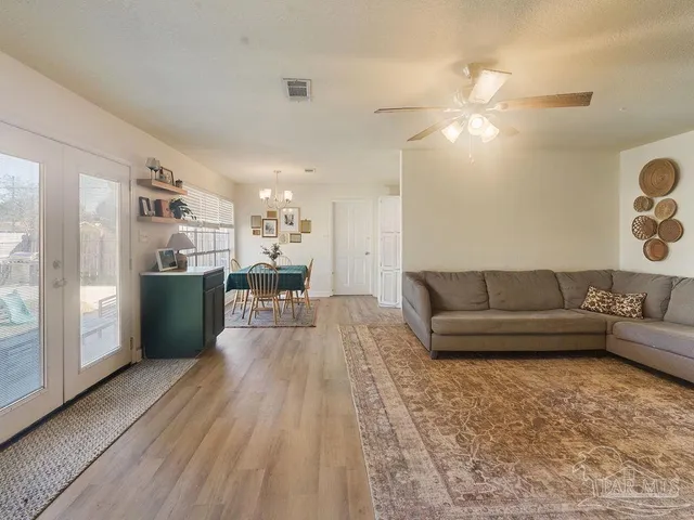 a living room with furniture and a kitchen view