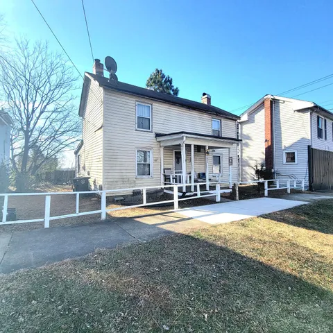 a view of a house with swimming pool and sitting area