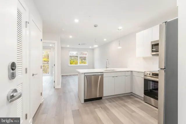 a kitchen with a sink stainless steel appliances and cabinets