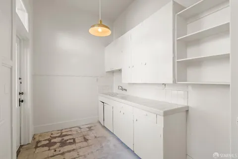 a kitchen with a sink cabinets and utility