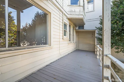 a view of a brick house with a large window and wooden floor