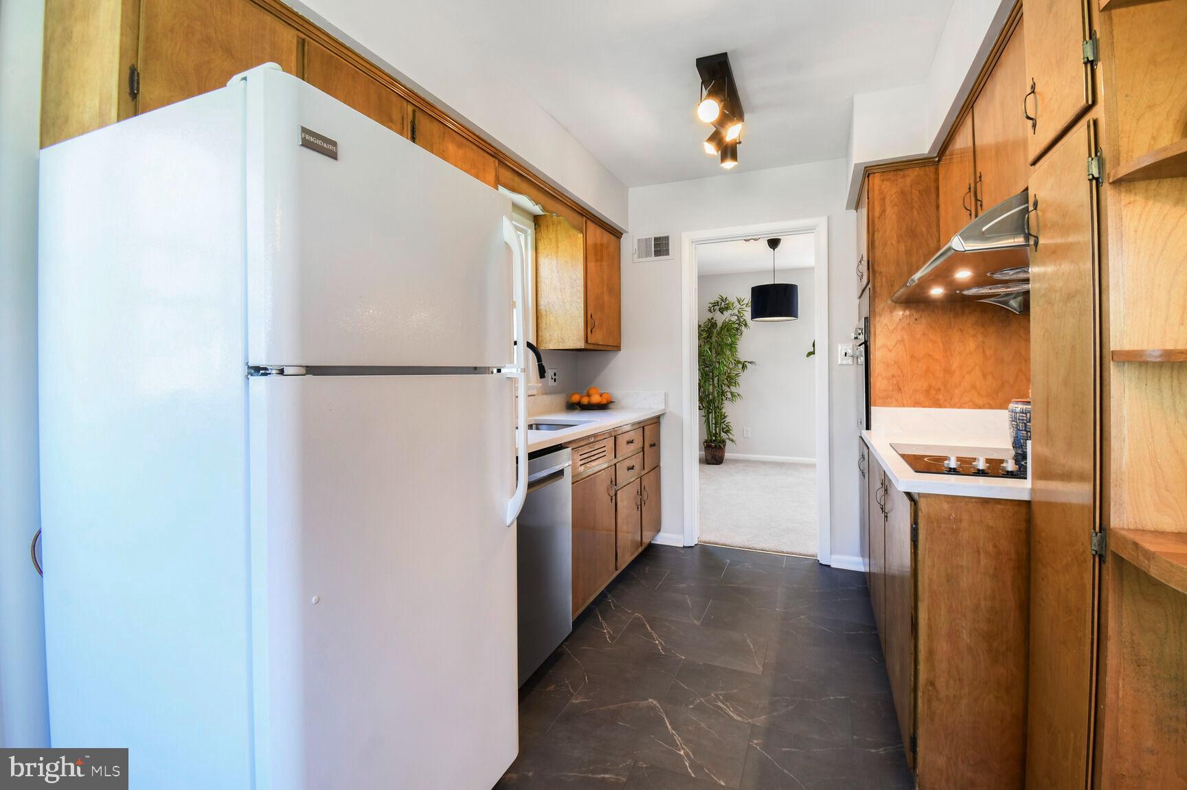 New track lighting, solid wood cabinets
