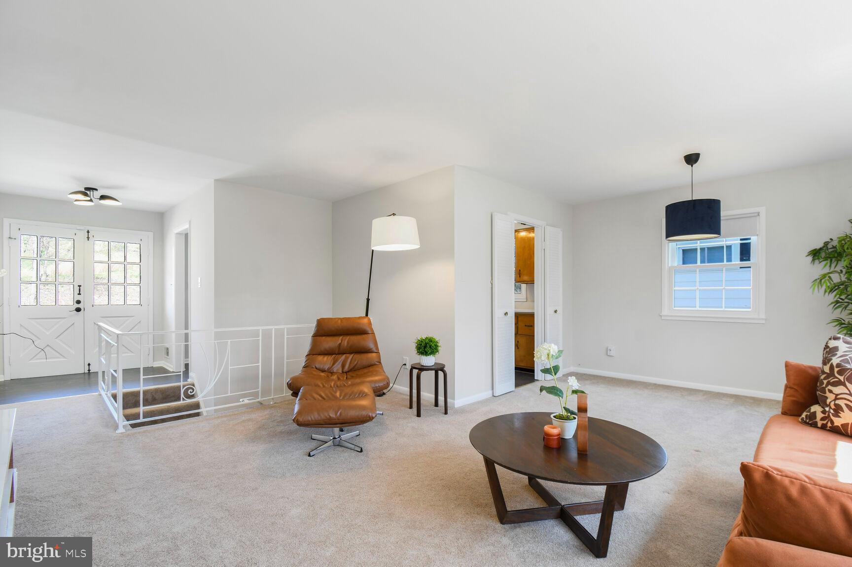 Living area; carpeting over hardwoods