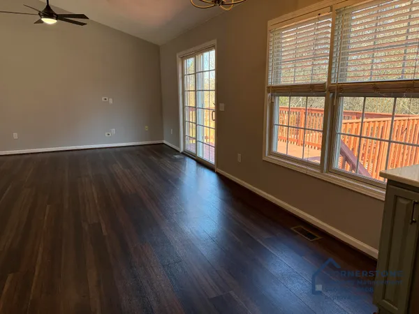 wooden floor in an empty room with a window