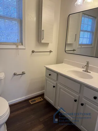 a bathroom with a sink mirror and vanity