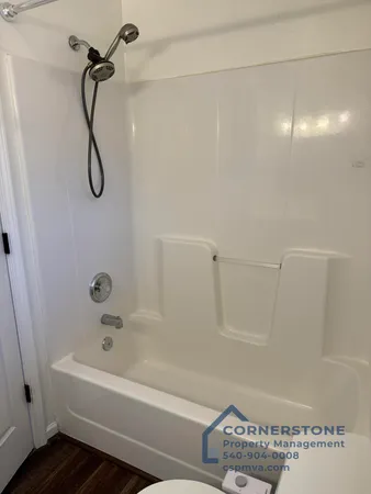 a bathroom with a bath tub with a shower