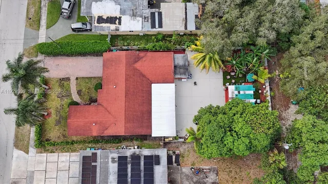 an aerial view of a house with a yard and lake view