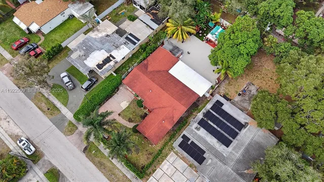 an aerial view of a house with a yard