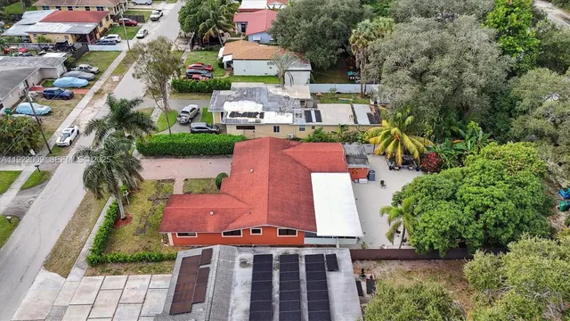 an aerial view of a house with a swimming pool outdoor seating and yard