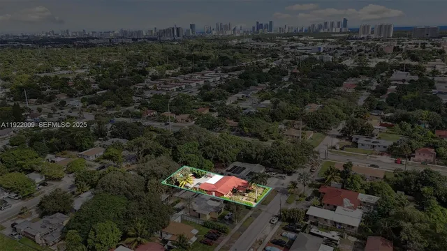 an aerial view of residential house with outdoor space and trees all around