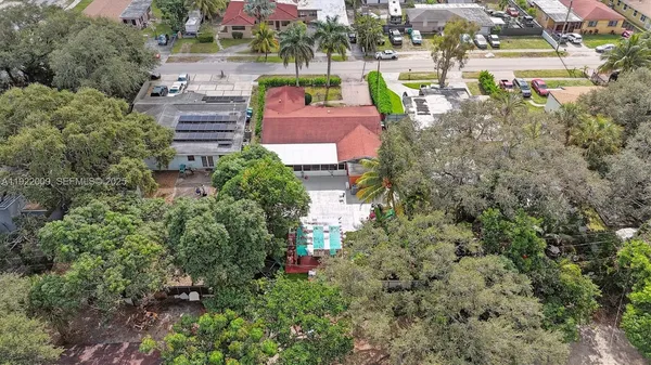 an aerial view of a house with a yard basket ball court and outdoor seating