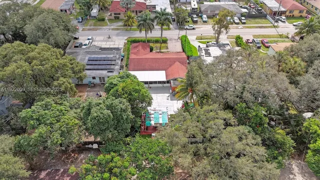 an aerial view of a house with a yard basket ball court and outdoor seating