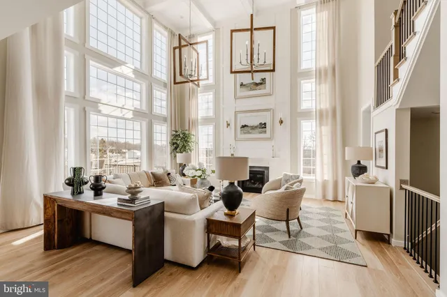 a living room with furniture and large windows