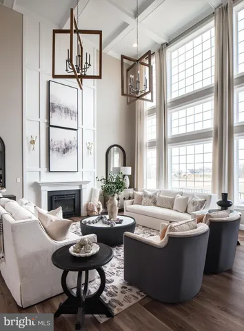 a spacious bedroom with a bed couch chandelier and a window