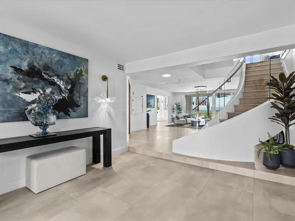 a kitchen with a sink a stove and chairs