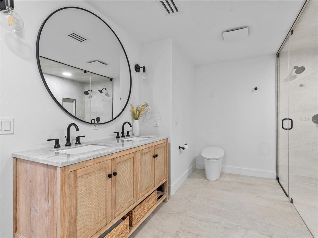 780 Eldorado Avenue Clearwater, FL 33767 - Photo 77 of 98 a bathroom with a toilet a sink and a mirror