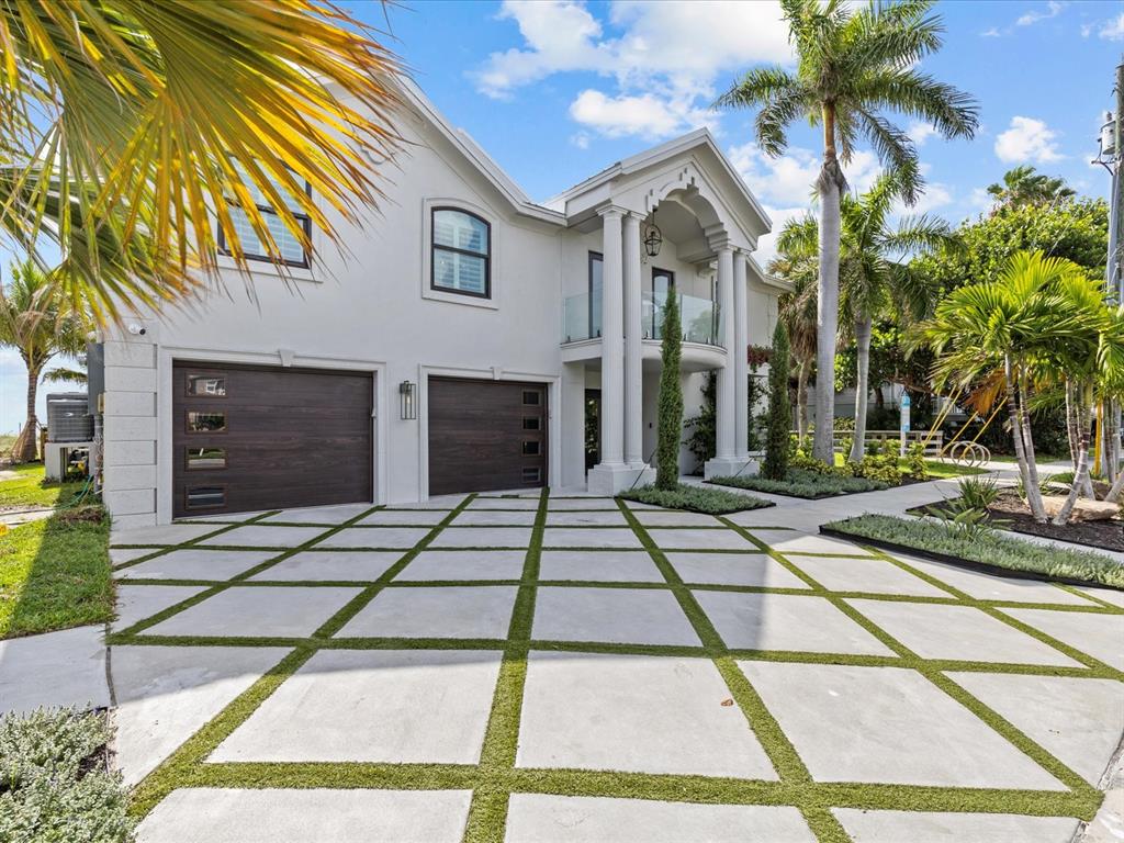 780 Eldorado Avenue Clearwater, FL 33767 - Photo 86 of 98 a view of a brick house with a small yard plants and palm trees