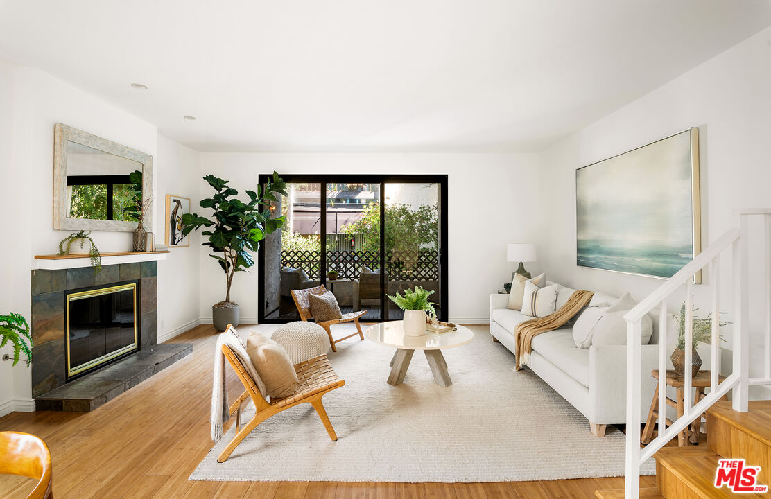 a living room with furniture fireplace and flat screen tv