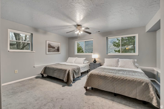 11789 Nicklaus Road Sandy, UT 84092 - Photo 24 of 58 Bedroom with a textured ceiling, carpet flooring, and a ceiling fan