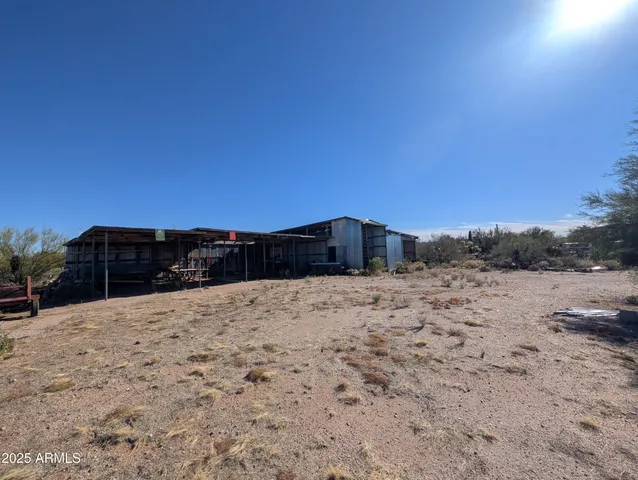 a view of a dry yard with a house