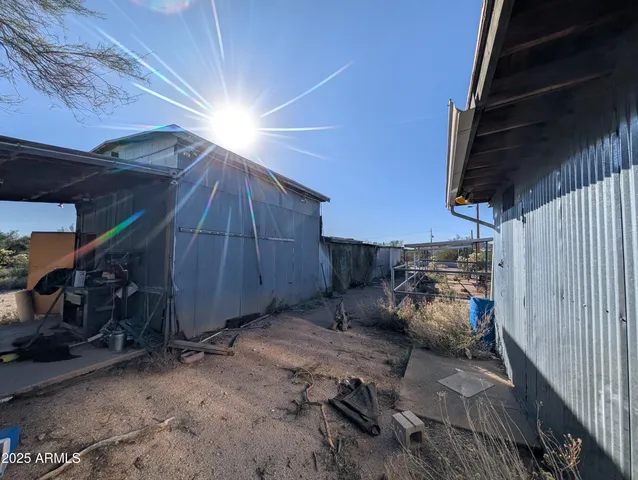 a view of dirt road with a building