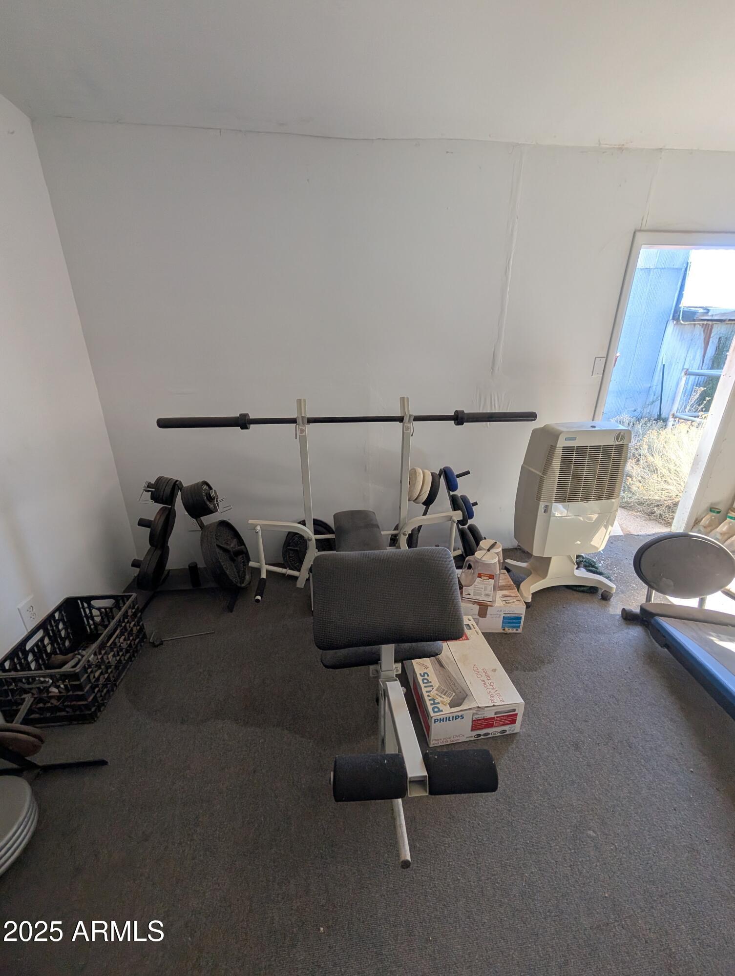 44000 East Fairmont Drive Tucson, AZ 85739 - Photo 38 of 49 a living room with furniture and a gym machine