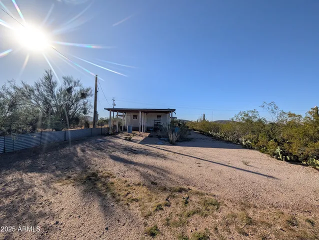 a view of a backyard with large trees