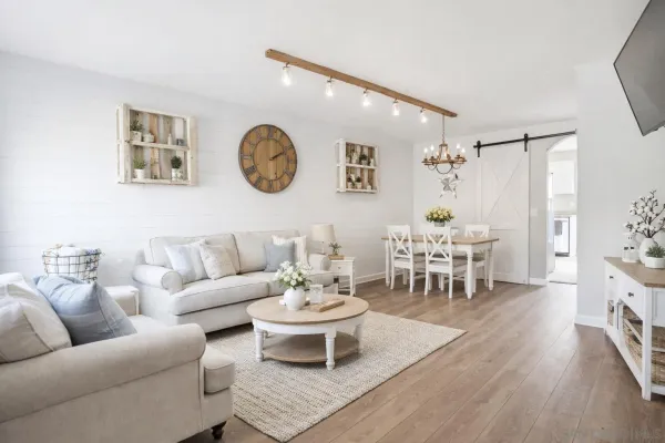 a living room with furniture and wooden floor