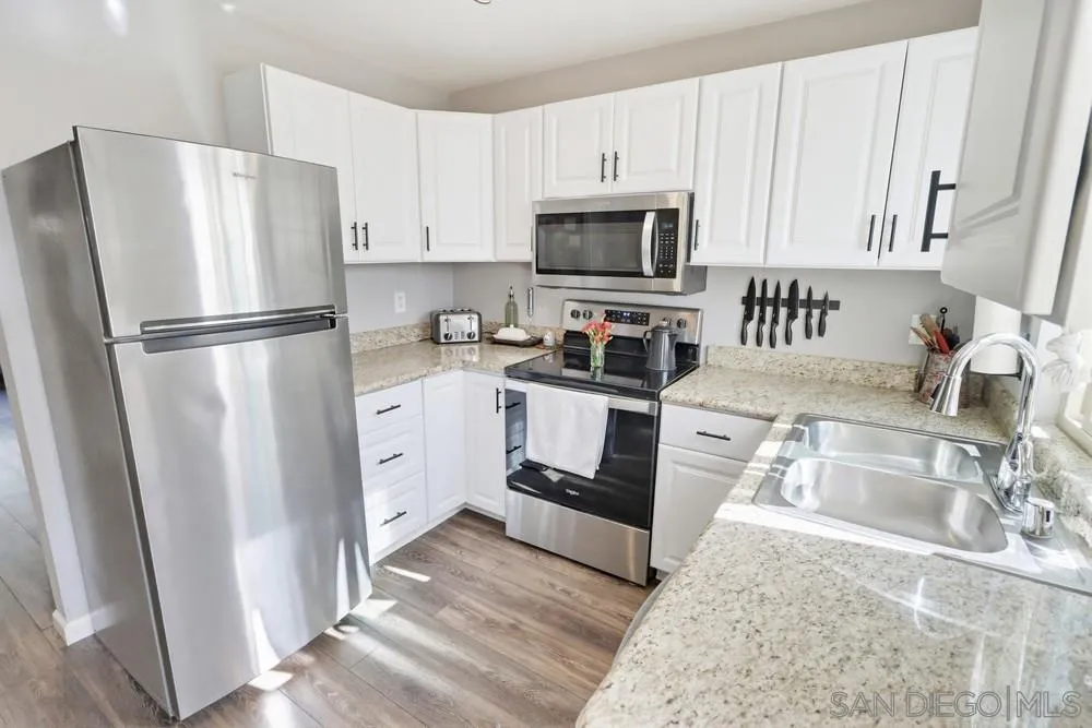 2616 Alpine Boulevard, Unit 28 Alpine, CA 91901 - Photo 11 of 34 a kitchen with white cabinets sink and stainless steel appliances