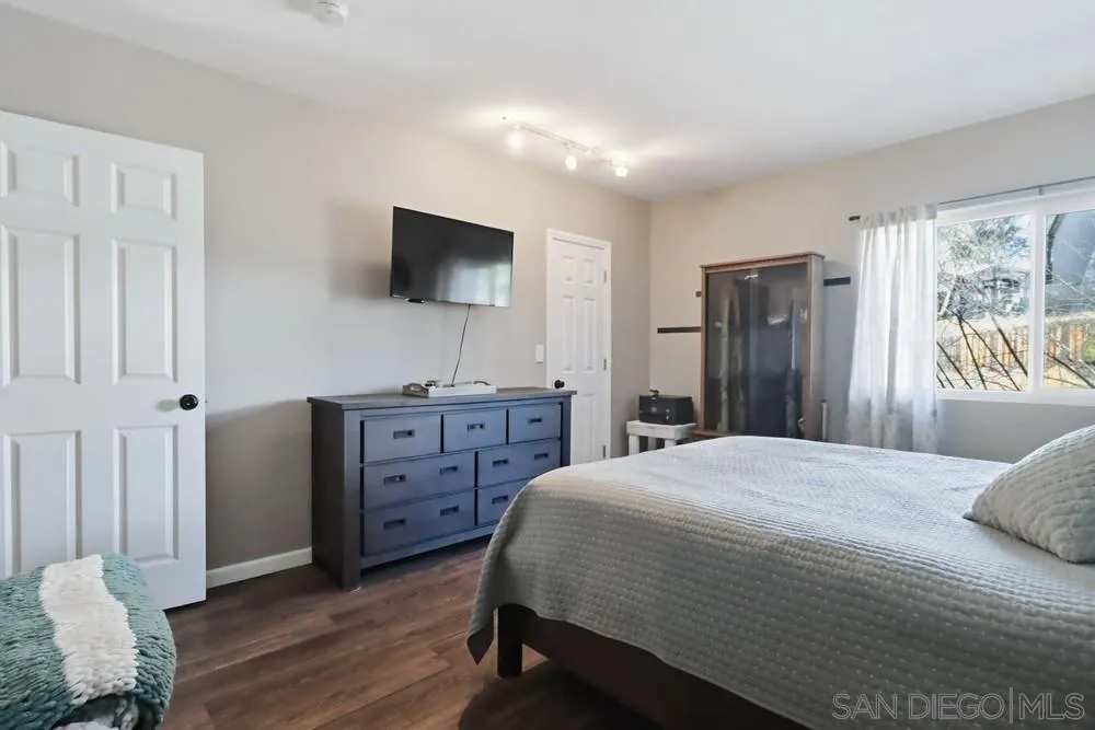 2616 Alpine Boulevard, Unit 28 Alpine, CA 91901 - Photo 20 of 34 a bedroom with a bed and a flat screen tv
