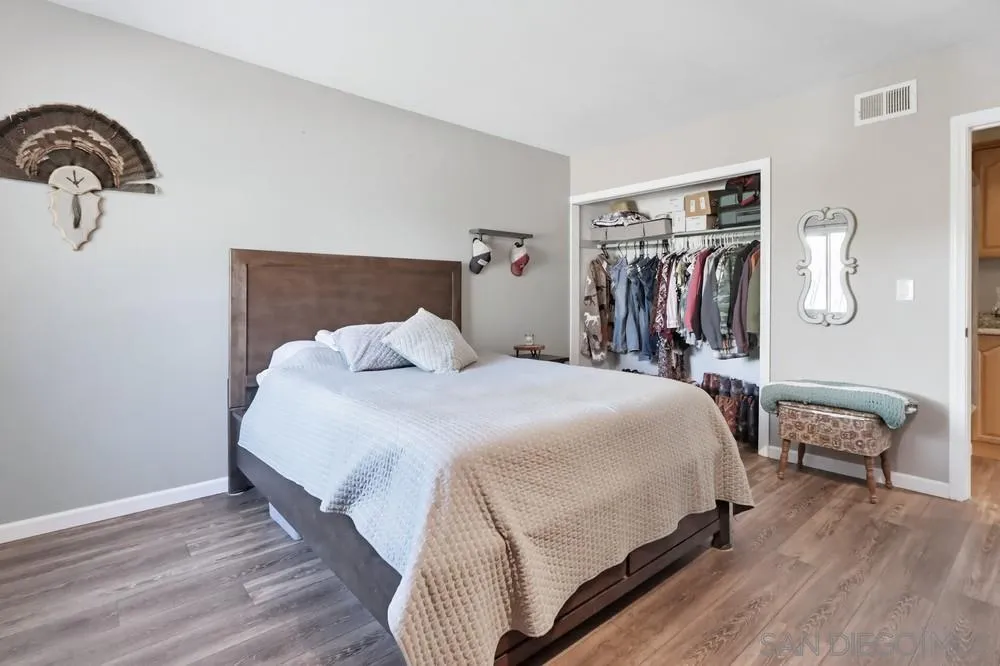 2616 Alpine Boulevard, Unit 28 Alpine, CA 91901 - Photo 21 of 34 a bedroom with a bed and wooden floor