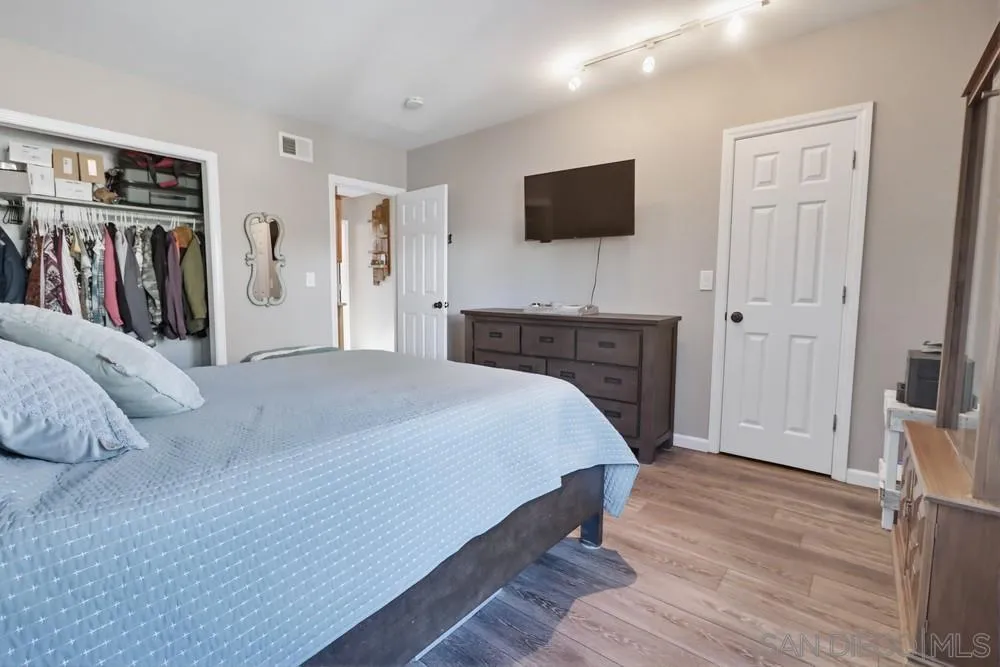 2616 Alpine Boulevard, Unit 28 Alpine, CA 91901 - Photo 22 of 34 a spacious bedroom with a bed and a flat screen tv