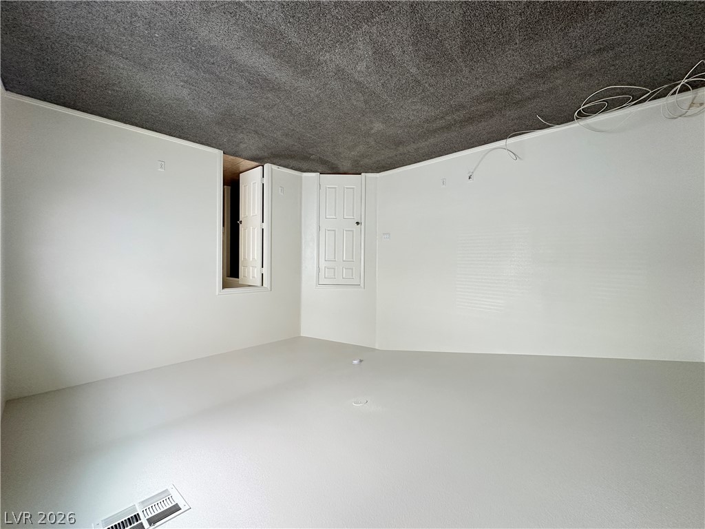 7305 Prussian Green Street Las Vegas, NV 89139 - Photo 15 of 23 A clean, versatile space awaits your personalized touch, featuring new flooring and white walls.