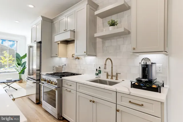 a stove top oven sitting inside of a kitchen