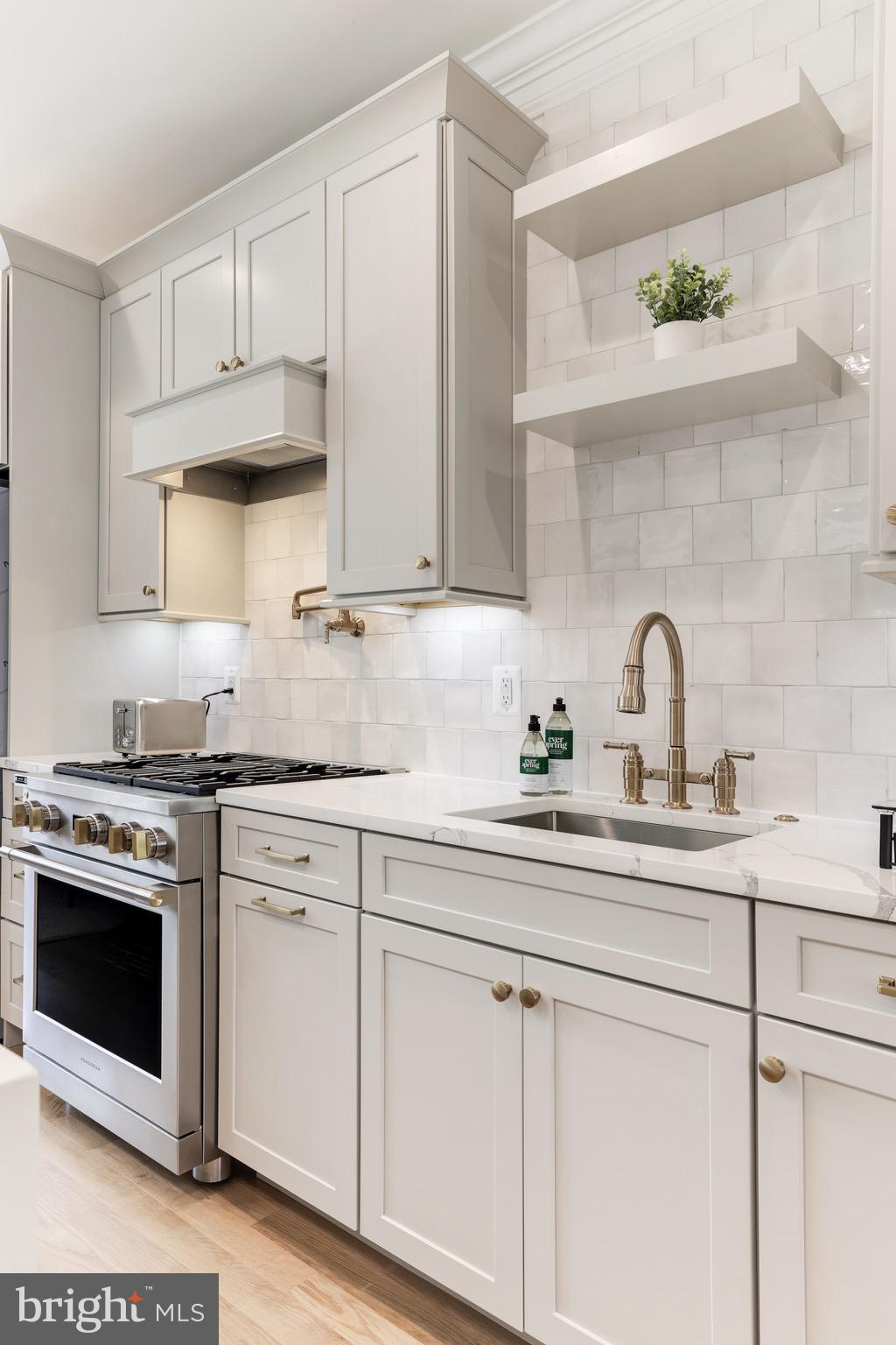 1415 Princess Street Alexandria, VA 22314 - Photo 16 of 63 a kitchen with white cabinets a sink and appliances