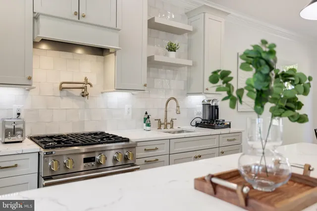 a kitchen with stainless steel appliances granite countertop a stove and cabinets