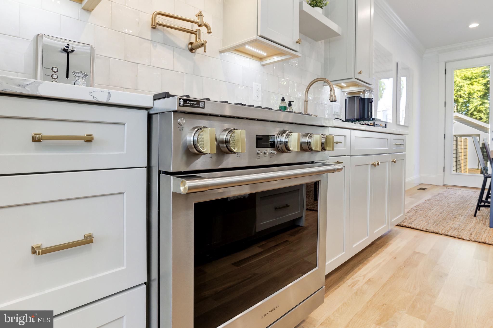 1415 Princess Street Alexandria, VA 22314 - Photo 21 of 63 a kitchen with stainless steel appliances granite countertop a stove and cabinets