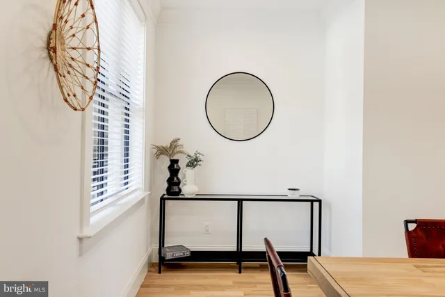 a bedroom with a bed and a large mirror