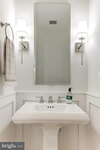 a bedroom with a bed a chair and dresser