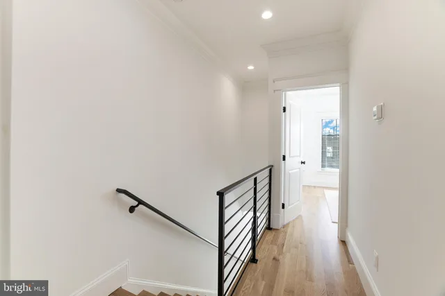 a view of a room with a chair and wooden floor