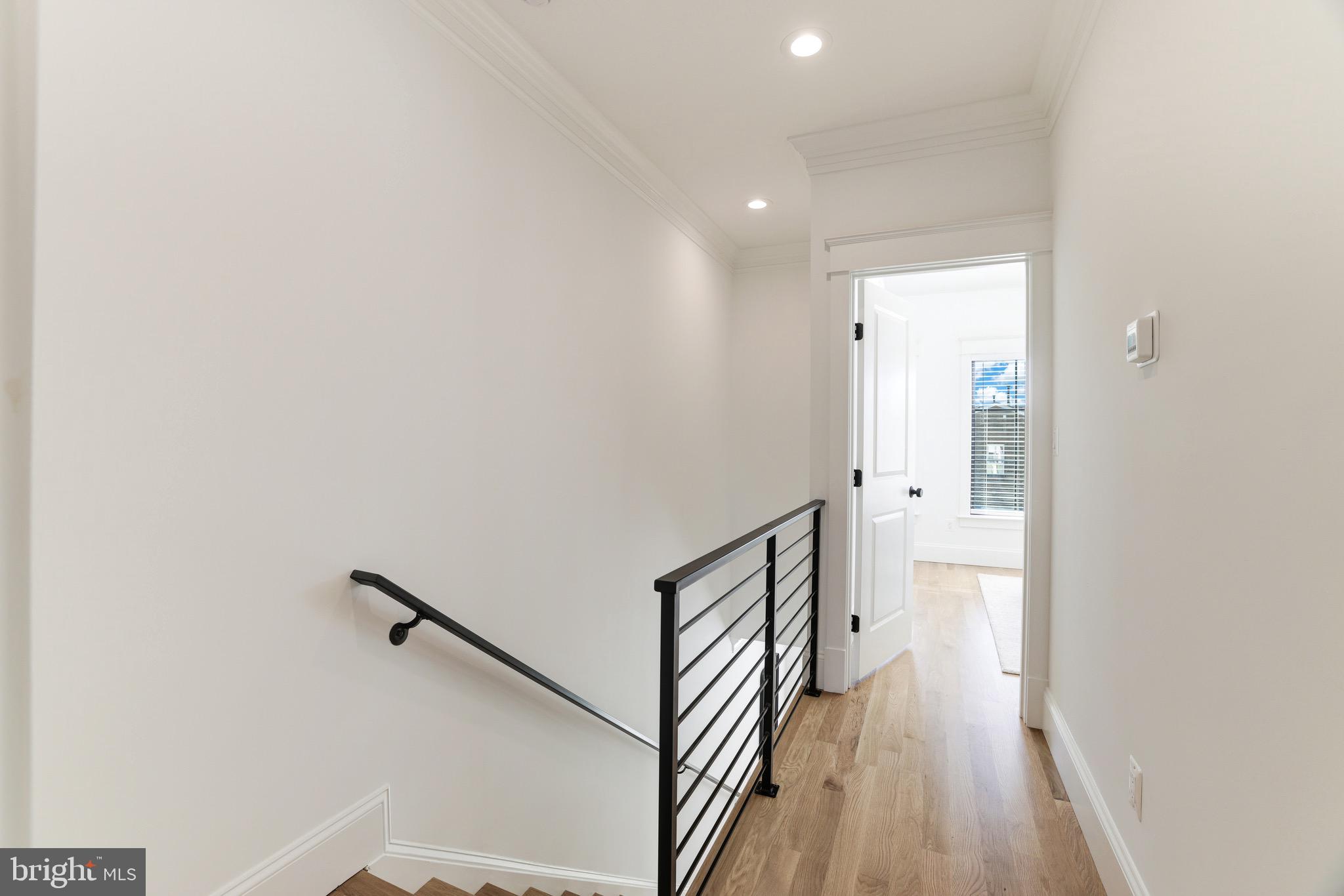 1415 Princess Street Alexandria, VA 22314 - Photo 36 of 63 a view of a hallway with wooden floor and staircase