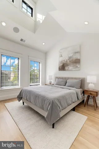 a bathroom with a sink vanity mirror and toilet