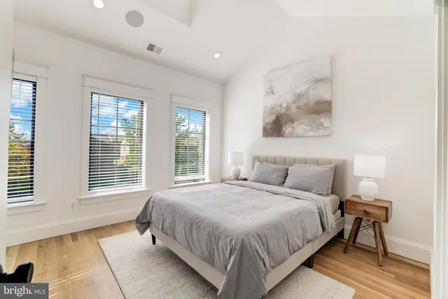 a view of a hallway with wooden floor and entryway