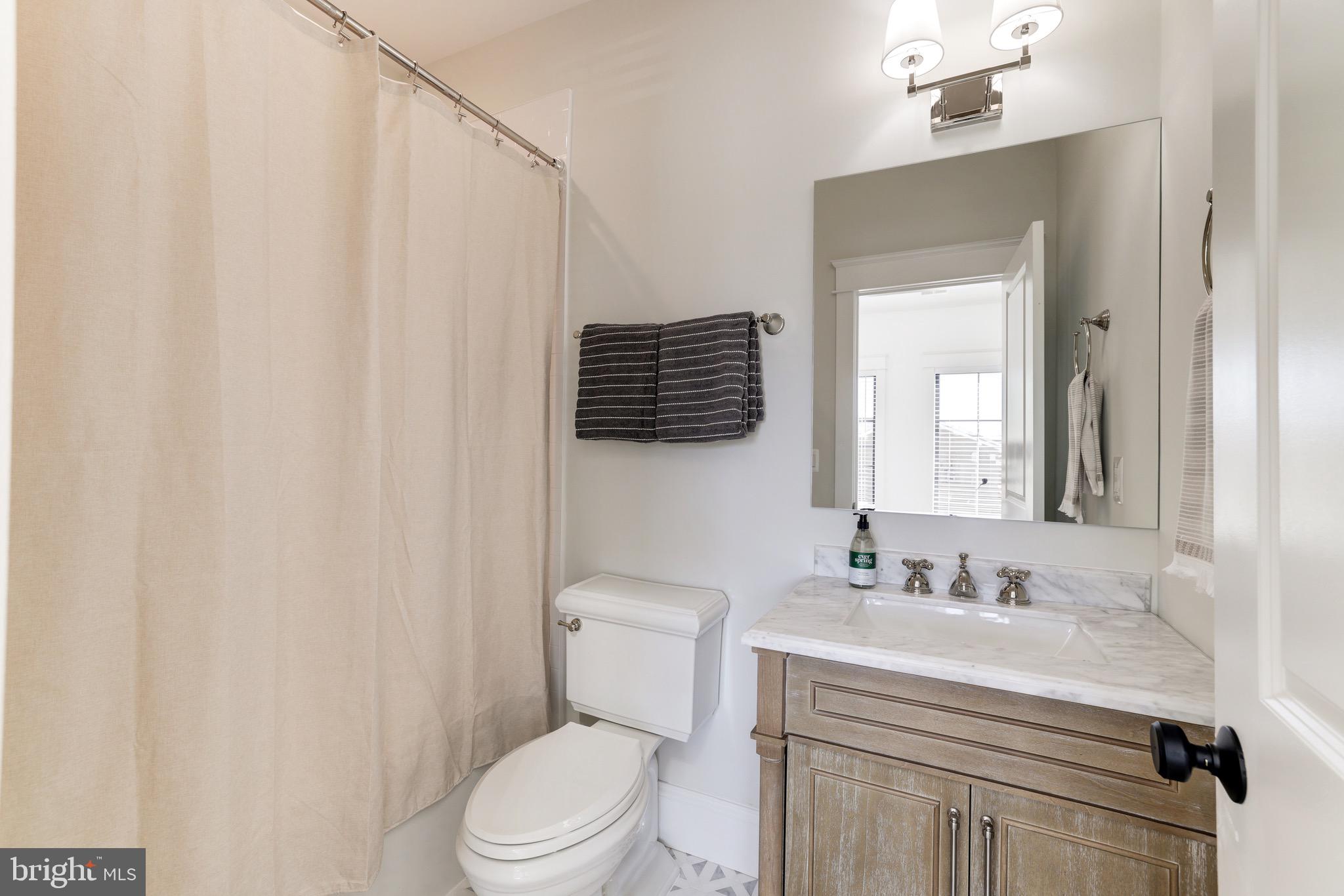 1415 Princess Street Alexandria, VA 22314 - Photo 47 of 63 a bathroom with a sink vanity mirror and toilet