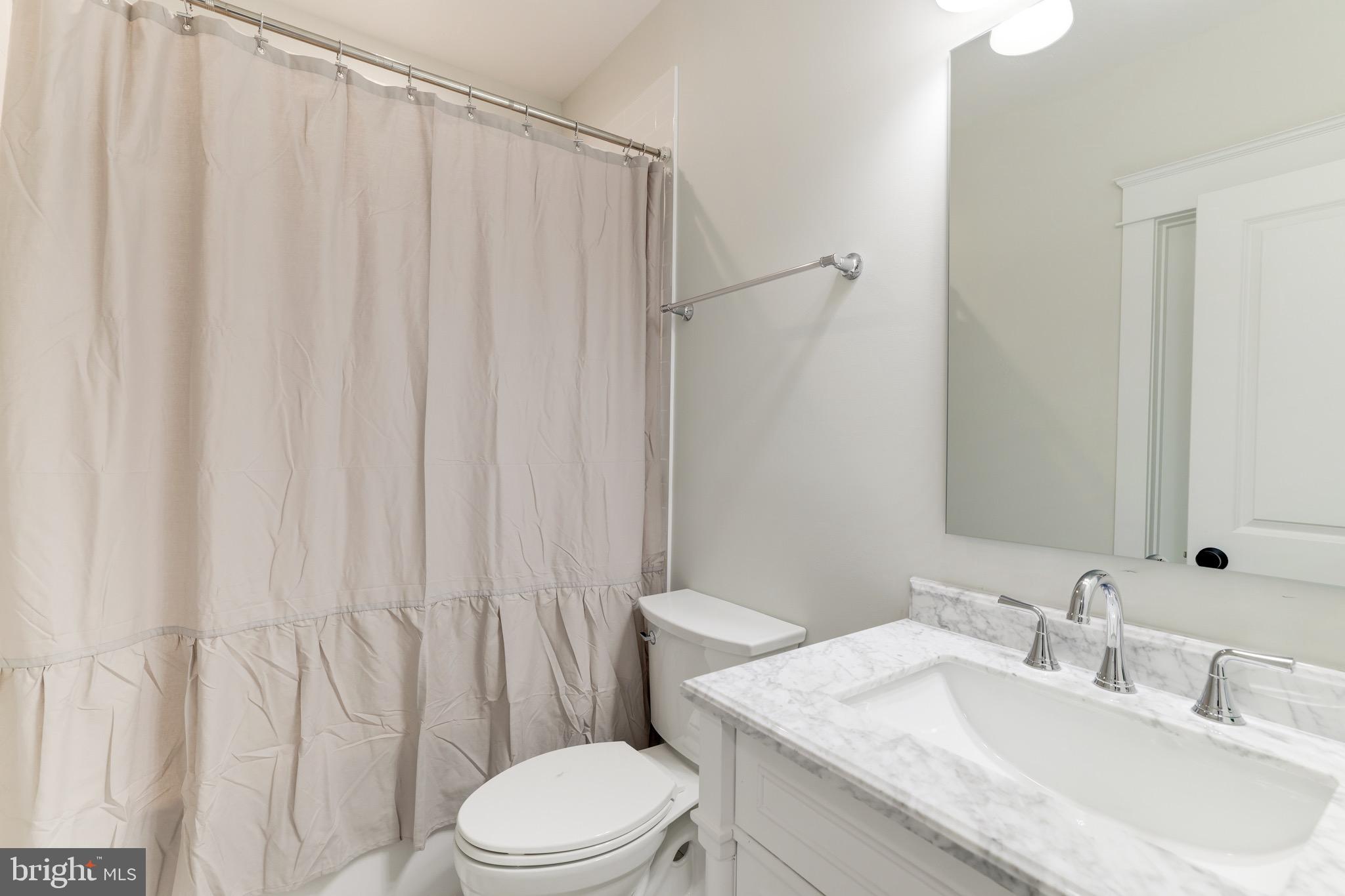 1415 Princess Street Alexandria, VA 22314 - Photo 52 of 63 a bathroom with a granite countertop sink and a toilet